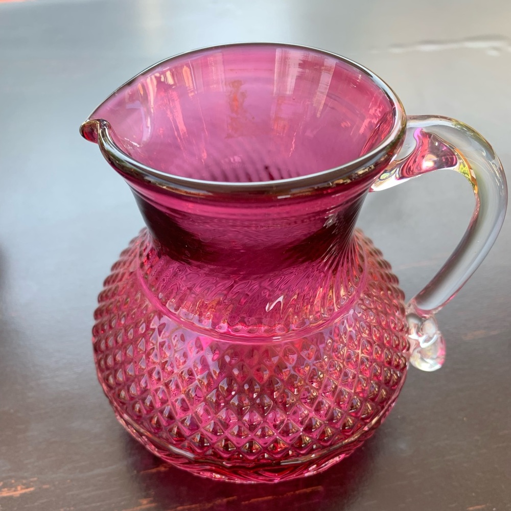 Cranberry glass creamer/small pitcher.